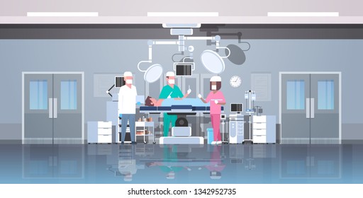 mix race surgeons team surrounding patient lying on operation table during surgery medical workers in operation room modern hospital clinic interior horizontal full length