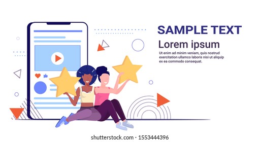 mix race women holding review stars customers rating client feedback satisfaction level concept girls using online mobile application sketch full length horizontal copy space vector illustration