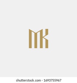 Logotipo en monograma en color dorado. M y K