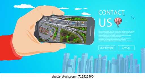 Mobile application contact us web page with hand holding white mobile phone with city map