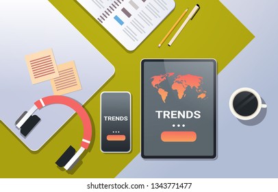 mobile application world global trends concept top angle view desktop smartphone tablet screen headphones office stuff horizontal