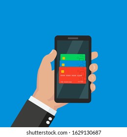 Mobile banking concept. Easy transaction with mobile banking. Credit and debit cards in your smartphone. Payment through internet. Hand holding a smartphone with set of different cards on the screen.