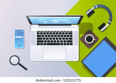 mobile computer app online top angle view workplace desktop with laptop smartphone screen office stuff horizontal