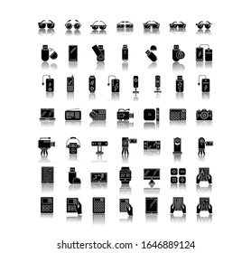 Mobile devices drop shadow black glyph icons set. Handheld electronic gadgets. Smart technology. Smartphone, laptop, computer. E-reader, camera, powerbank. Isolated vector illustrations on white space