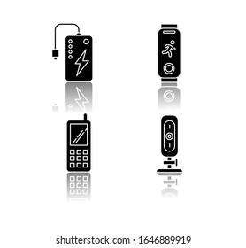 Mobile devices drop shadow black glyph icons set. Pocket electronic gadgets. Smart technology. Powerbank. Fitness tracker. Cell phone, web camera. Isolated vector illustrations on white space
