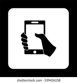 Mobile phone in hand -  black vector icon