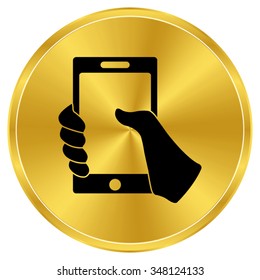 Mobile phone in hand - gold vector icon
