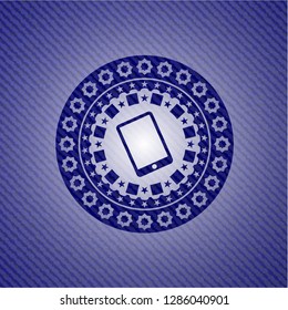 mobile phone icon inside badge with denim texture