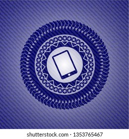 mobile phone icon inside jean or denim emblem or badge background