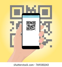 The mobile phone smartphone in hand scans the QR code