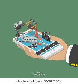 Mobile video editor flat isometric low poly vector concept. Hand with smartphone and equipment for movie creating like film strip, camera, directors chair on it. 