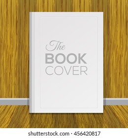 Mock up of white book cover with wood wall background.