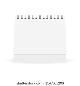 Mock up white paper calendar stands on a table