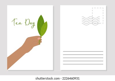 a mock-up of a greeting card with a tea day hand holding tea leaves