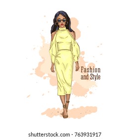 Model of African descent demonstrates the dress. Fashion look. Hand drawn sketch. Vector illustration.