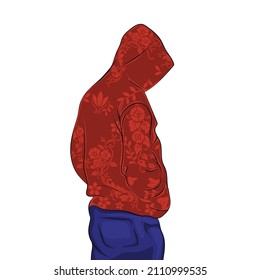 Modelo con capucha roja estampada y vaqueros azules, manos en bolsillos.