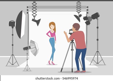 Model in photo studio. White background with lights and cameras. Photographer making photos. Fashion clothes.