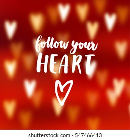 Modern abstract blurred red background with bokeh effect hearts. Follow your heart hand lettered text. Love concept. Valentine vector card,  illustration. 