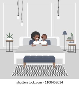 Modern bedroom interior. Couple of young african american adults lying in the double bed. Scandinavian design.