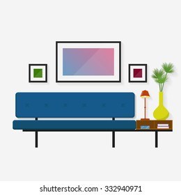 Modern blue sofa with a convenient shelf for books with a yellow vase and table lamp.