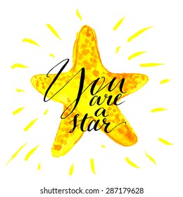 Modern calligraphy inspirational quote - you are a star- at yellow shiny watercolor background. Vector card or poster design with unique rough typography.