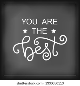 Modern calligraphy lettering of You are the best in white on blackboard background stylized as chalk lettering for decoration, design, sticker, logo, stamp, postcard, greeting card, gift tag, poster