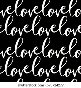 Modern calligraphy style seamless repeating pattern with the word love in white on black background. Valentine's Day greeting card template, poster, wrapping paper.