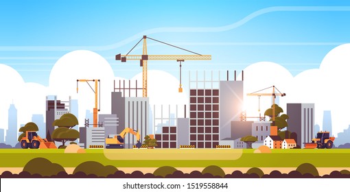 modern construction site with cranes tractor and bulldozer unfinished building exterior sunset background flat horizontal
