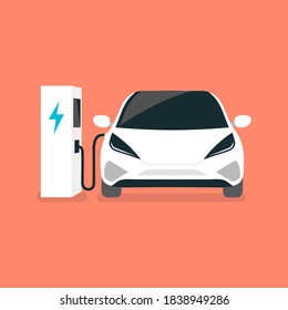 Modern electric car charges on an electric vehicle EV charging station point.