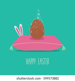 modern & elegant beautiful vector icon one single clean & simple chocolate egg with stars for happy easter on a pillow or cushion illustration isolated with a little bunny or rabbit hiding behind.
