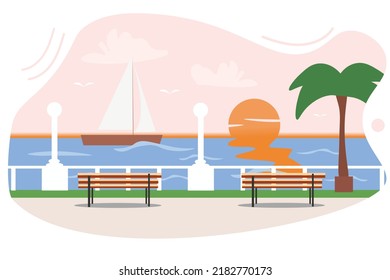 Modern embankment at sunset with palm trees and lanterns.