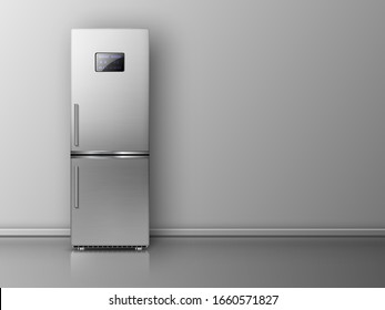 Modern fridge in front of grey wall.