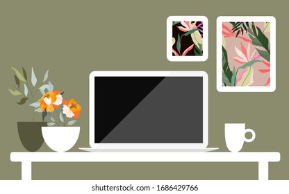 Modern home work desk. Work space at home. Work from home. Worldwide quarantine concept. Contemporary interior design. Laptop, coffee cup and flowers in pots on the table, frames on the wall.