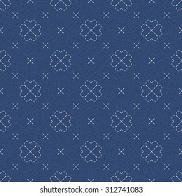 The modern interpretation of sashiko, a traditional Japanese needlework, on a dark blue denim background. Seamless pattern with embroidered hearts joined together in four leaf clover. 