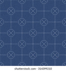 The modern interpretation of sashiko, a traditional Japanese needlework, on a dark blue denim background. Seamless pattern with hearts, joined in four leaf clover. Background divided into squares.