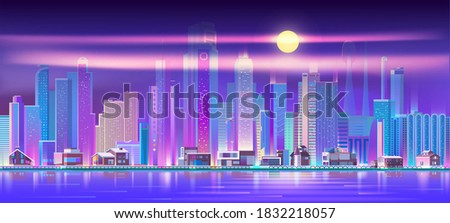 Illuminated city on seashore at night