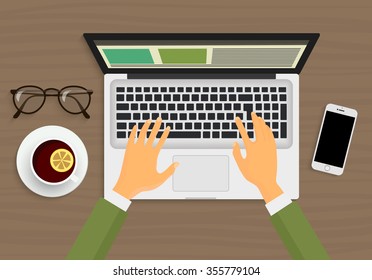 Modern person hands working on the laptop sitting in Cafe. Top view workplace. 