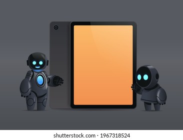 modern robots couple standing near tablet pc with blank screen robotic character artificial intelligence technology