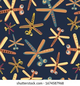 Modern seamless stylised design with colourful abstract cartoon dragonflies with big eyes on a dark blue background. Can be used for printing on paper, stickers, badges, bijouterie, cards, textiles. 