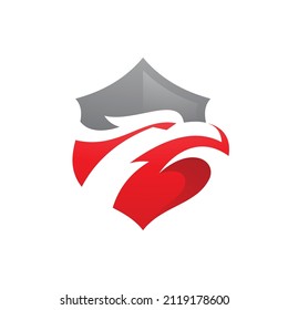 Modern shield and bird head logo design. Shield and eagle falcon hawk head emblem vector icon. Negative space design with vibrant gradient color
