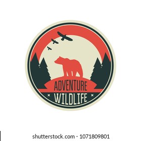 Modern shield forest camp badge. Vector graphic camping logo with bear. Exploration camp, tourism extreme sport club emblem, logo design. Wild travel sticker. 