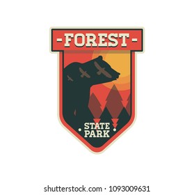 Modern shield forest camp badge. Vector graphic camping logo with bear. Exploration camp, tourism extreme sport club emblem, logo design. Wild travel sticker. 