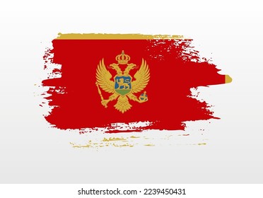 Modern style brush painted splash flag of Montenegro with solid background