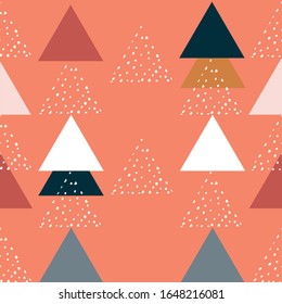 Modern stylish abstract geometric background with colorful triangles in trendy style. Repeating texture of dots in white, black and gray elements on the orange background. Vector seamless pattern.