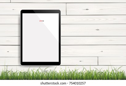 Modern tablet computer on white vintage wooden texture background with green grass field area. Vector illustration.