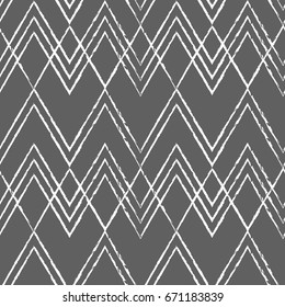 Modern vector seamless pattern with chevron stripes. Ikat fabric style geometric repeat in retro pastel colors.