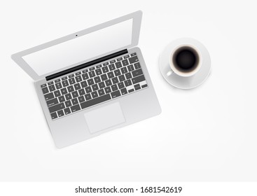 Modern white laptop with coffee cup. Top view