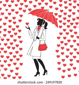 Modern young woman with an umbrella in the rain of red hearts, a way of love and Valentine Day