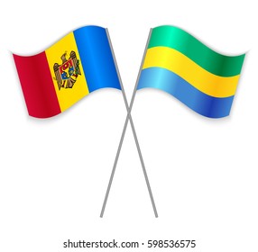 Moldovan and Gabonese crossed flags. Moldova combined with Gabon isolated on white. Language learning, international business or travel concept.
