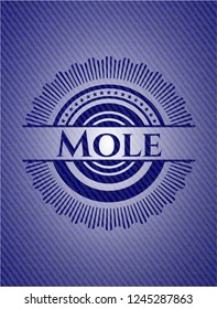 Mole badge with denim background